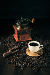 Wall Mural - Cup of coffee and beans at wood table. Homemade coffee at table