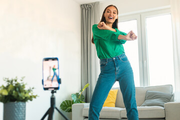 Wall Mural - Happy Lady Blogger Dancing Making Video On Cellphone At Home