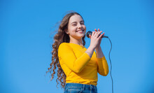 Happy Teen Girl Singing Song In Microphone