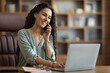 © Prostock-studio - Positive pretty young businesswoman having phone call