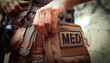 © Zhanna - A soldier, a tactical medic opens a first aid kit, close-up view.