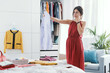 © StockPhotoPro - Woman choosing clothes in her bedroom