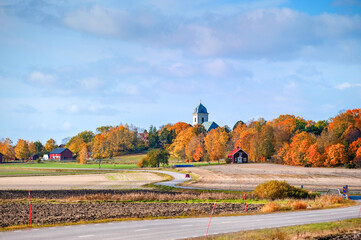 Winding road in the countryside of Vikbolandet during autumn in Sweden