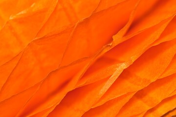 Wall Mural - Orange colored ruffled paper cells abstract patterns and textures background with shallow depth of field.