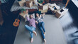 © silverkblack - High shot of young couple lying on floor of their new house in bedroom, talking, laughing . Carton boxes, guitar, carpet and bed are visible.