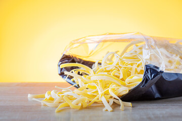 pasta in transparent plastic bag on a kitchen table. dried homemade pasta.