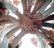 © ASDF - bottom view . group of young people joining their palms together