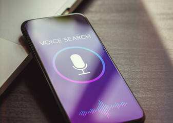 Wall Mural - voice search, speech recognition and sound detect app concept with close up smartphone lying on a bl