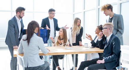 Wall Mural - working group discussing a new strategy near the desktop.