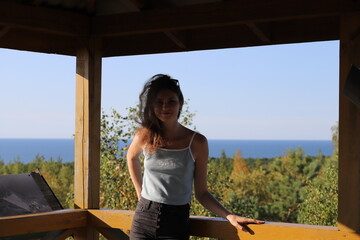 portrait of a young girl on a background of trees