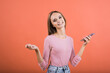 © Павел Костенко - The girl uses a mobile phone, works on the Internet on a red background.