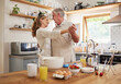 © N Lawrenson/peopleimages.com - Love, breakfast and senior couple dance in kitchen for romance and happy life together in house. Married retirement people smile with happiness enjoying cooking dancing break in Canada home.