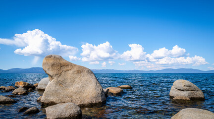 Wall Mural - Bear or animal-shaped glacial rocks at tranquil Lake Tahoe with clean blue water and dramatic clouds in Logan Shoals Vista Point in Nevada