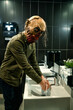Zombie washing hands in sink looking at camera