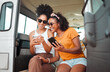 © Kay Abrahams/peopleimages.com - Black friends, phone and social media travel in communication together for road trip adventure. Happy and excited African American women sharing moments of traveling on mobile smartphone for vacation