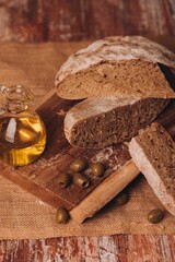 Canvas Print - Composition with fresh bread, green olives, and olive oil on the table