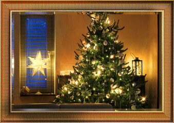 Wall Mural - illuminated decorated christmas tree seen through framed mirror