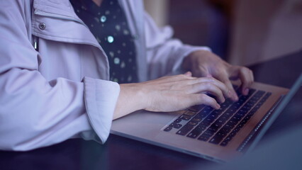 Closeup woman hands typing on computer laptop. Person working remotely with laptop closeup female hand