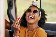 Happy, Road Trip And Black Woman Eating A Strawberry In A Car On A Travel Holiday In Nature. Portrait Of A Young, Funny And African Girl With Fruit In A Van On Vacation For Adventure And Freedom