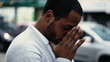 © Marco - One spiritual young black man praying in street having HOPE and FAITH. African American prays in city urban sidewalk