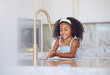 Little girl, washing and hands with smile in the kitchen for healthy clean hygiene at home. Happy black female child rinsing and cleaning hand by the sink at the house after a day outside