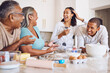 © Beaunitta Van Wyk/peopleimages.com - Black family, kitchen and happy for cooking, baking and bonding in home. Family, comic and conversation for happiness, love and time together on holiday, vacation or break to relax, talking and fun