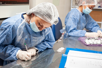 Scientist preparing paraffin blocks containing biopsy tissue for sectioning. Pathology laboratory. Cancer diagnosis.