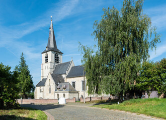 Kobbegem, Flemish Brabant Region, Belgium  - Paved road and catholic church of the village