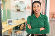 © Vadim Pastuh - Ambitious female entrepreneur ceo manager stands in contemporary office space with arms crossed leaned on glass partition, smiling businesswoman looks at camera