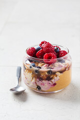 Wall Mural - Overnight oatmeal with berry, peanut butter and maple syrup in jar. Healthy breakfast concept.