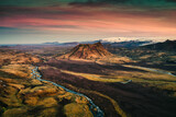 Fototapeta Góry - Extinct volcanic crater among the lava field and river flowing through at the sunset in Icelandic Highlands on summer