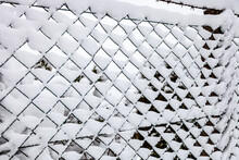 Chain Link Fence With Snow Background In Wintertime