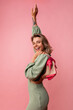 © Look! - Happy young caucasian lady with snow-white smile looks at camera on pink background. Blonde wears dress and shoes. People emotions, lifestyle and fashion concept.