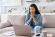 © Stock 4 You - Nervous asian woman looking at laptop screen worrying about bad news