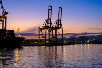 Poster - Malaga Port loading cranes at sunset