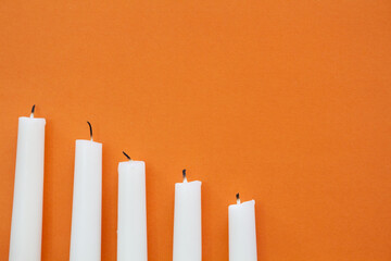 orange Halloween flat lay with white candles