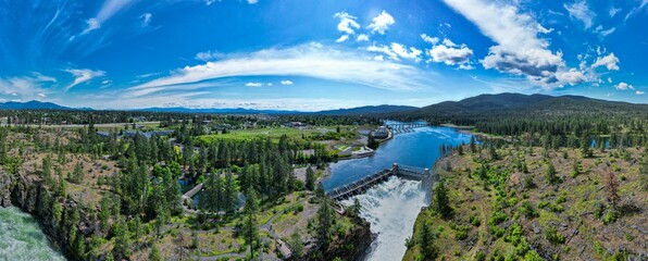 Sticker - Arial view of Post Falls Dam surrounded by trees with blue sky in the background