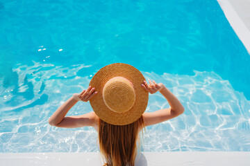 Wall Mural - top view. a woman in a straw hat in the pool.