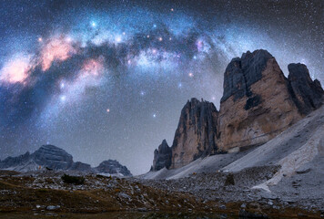 Wall Mural - milky way arch over mountain peaks at night in summer. beautiful landscape with blue sky with arched