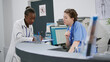 © DC Studio - Diverse medical team working at hospital reception counter to help patients with consultation appointments and checkup visits. Doctor and nurse checking report papers. Handheld shot.