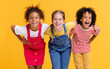 © JenkoAtaman - Group of cheerful happy multinational children on  yellow background