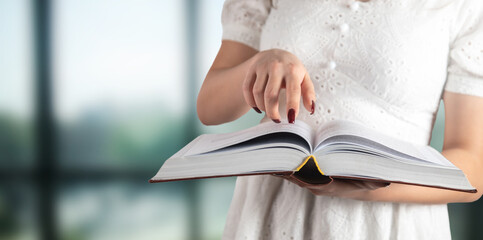 Young woman pointing at the book