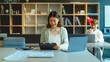 © NanSan - Using laptop, Beautiful young Asian businesswoman working at workspace.