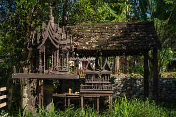 Poster - Old wooden structure of the spirit house or Shrine of the household god, Phra Phum Shrine, Joss house in Thai culture.