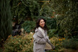 © olga pink - Portrait of pretty asian kazakh brunette woman with charming smile walking along outdoors