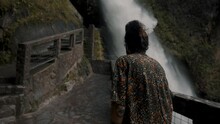 Back View Of A Person Walking On The Viewing Balcony At Devil's Cauldron Waterfall In Rio Verde, Banos Ecuador.