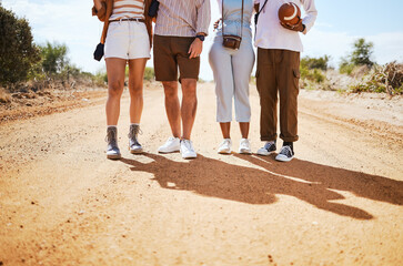 Canvas Print - Shoes, shadow and friends on a sand road in the desert for summer holiday or vacation while walking together in nature. Travel, legs and adventure with a man and woman group standing on a footpath