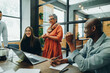 © Jacob Lund - Diverse businesspeople smiling cheerfully during an office meeting