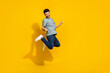 Full size portrait of overjoyed delighted person jumping rtaise fists celebrate isolated on yellow color background
