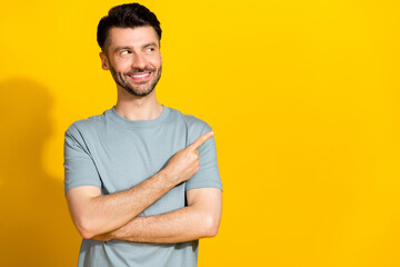 Wall Mural - Photo of cheerful man wear khaki clothes interested look empty space black friday low price shop isolated on yellow color background